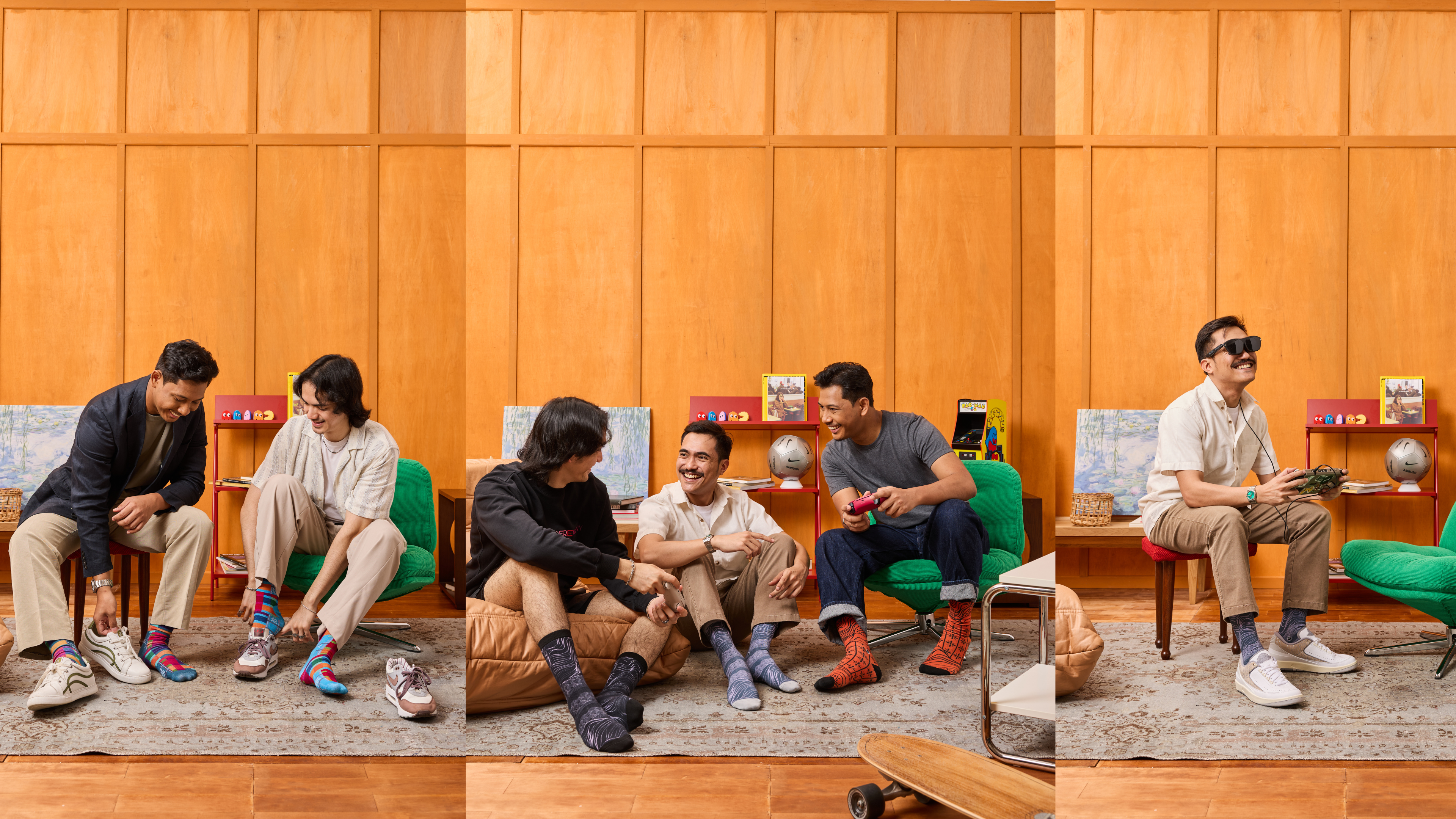 People sitting on a wooden floor with skateboards, surrounded by various items, wearing colorful socks.
